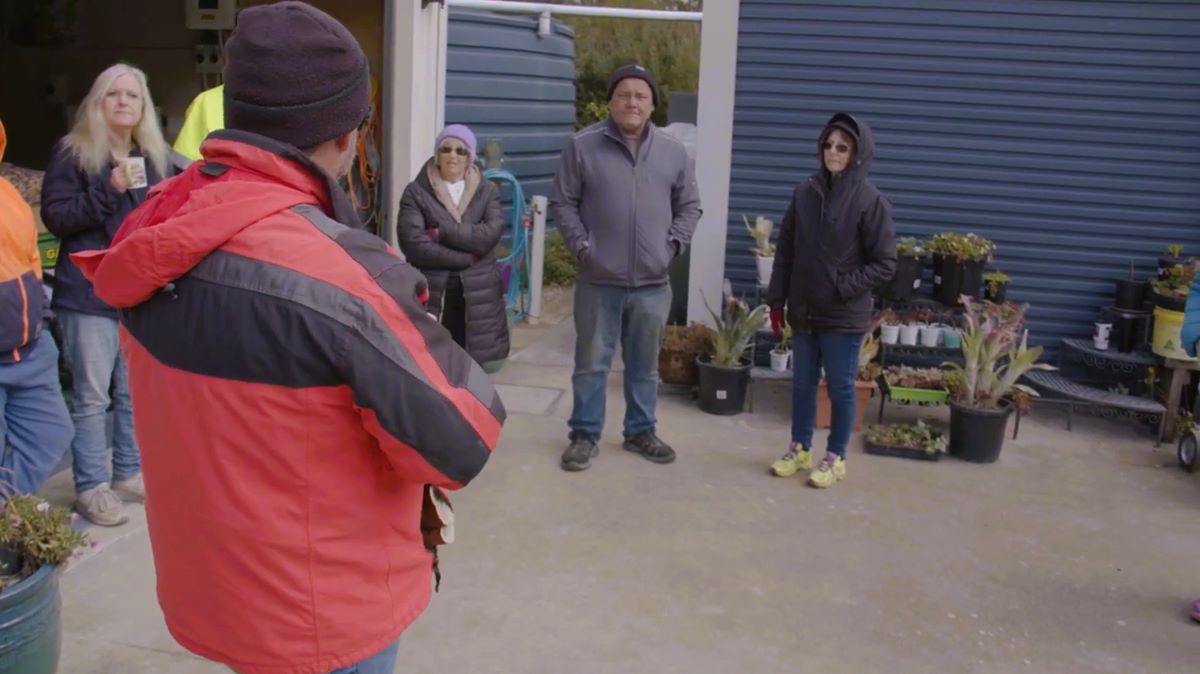 Tony talking with community members about water tanks.