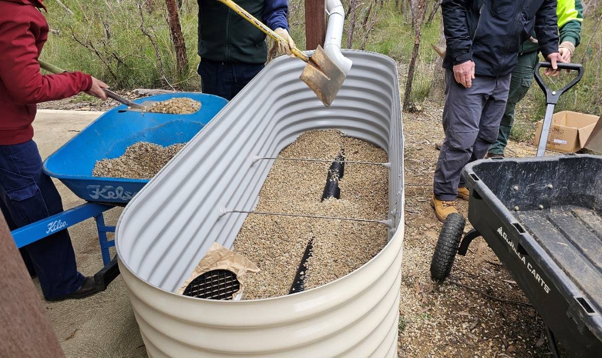 filling a rain garden with gravel